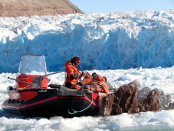 Julie Brigham-Grette and REU students collect sediment from an iceberg. The icebergs are a prime source of sediment samples. Kongsfjorden, Ny Alesund, Svalbard, Norway.