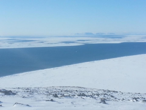 Shorefast ice and open lead near Wales.